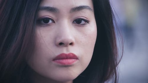 depressed and sad chinese woman in the city: Closeup Portrait