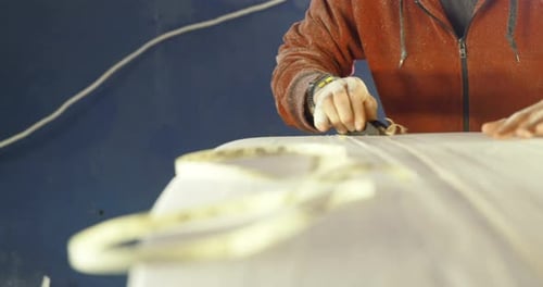 Man making surfboard 4k
