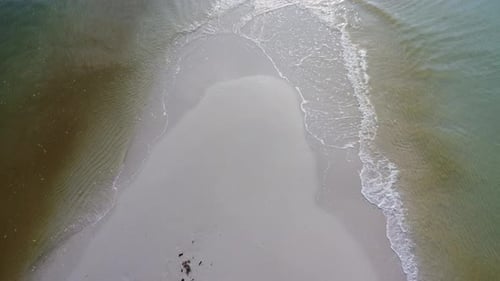 Sandy beach jutting out into the middle of the sea with beautiful water.