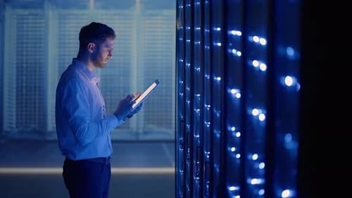 IT Technician in Data Center Digital Server Room Controlling Work of Rack Server Cabinets with a