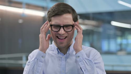 Man Rubbing Temples, Headache or Migraine