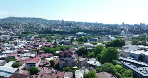 Aerial view of Tbilisi city central park and Bridge of Peace. Beautiful cityscape of old Tbilisi at