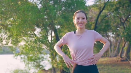Asian active sport woman stand with confidence after exercise outdoors.