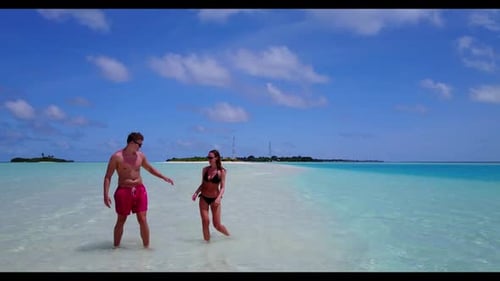 Young couple happy together on tranquil tourist beach adventure by transparent ocean with clean sand