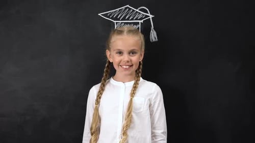 Girl Smiling in Front of Graduation Cap Drawing
