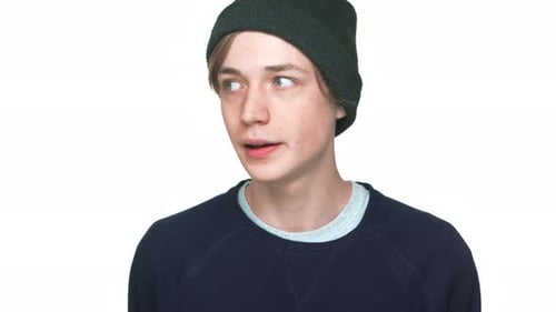 Portrait of Blueeyed Nervous Teen Guy Wearing Sweatshirt and Hat Want to Say Truth Hinting at