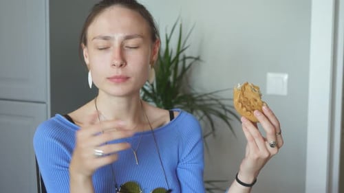 Woman Eating Pastry Treat Indoors