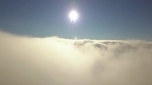 Reveal shot of aerial view from above of white puffy clouds