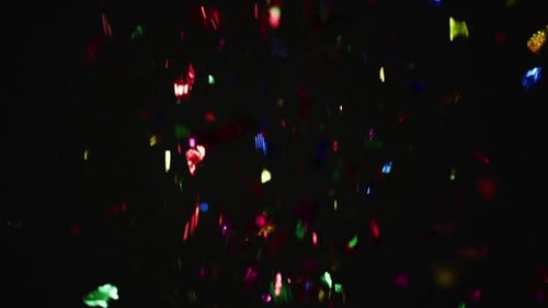 Falling Colorful Confetti Against Black Background