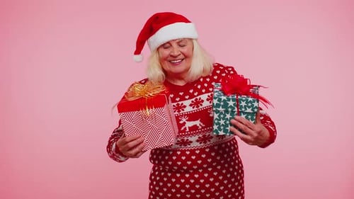 Senior Woman Holds Christmas Gifts and Smiles