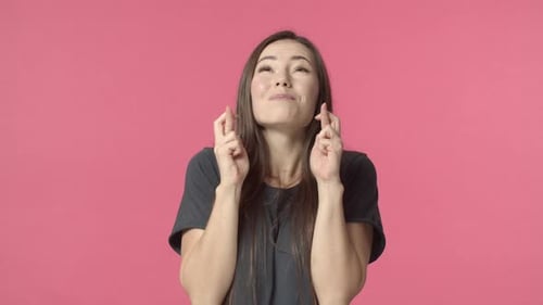 Young Woman Crossing Fingers for Luck and Success
