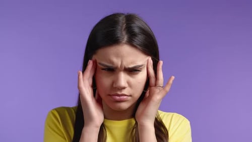 Portrait of Woman Having Headache Violet Studio Portrait