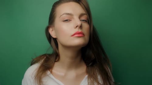Beautiful Woman Posing Against Green Background