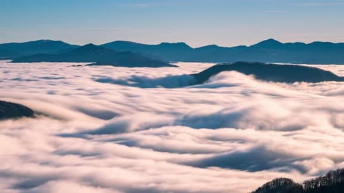 Sweeping Aerial View of Clouds and Mountains