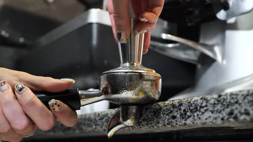 Barista Tamping Coffee Grounds for Rich Espresso