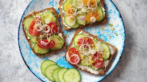 Colorful Open Faced Sandwiches on a Blue Plate