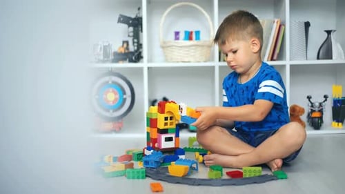 Boy Playing with Colorful Building Blocks at Home