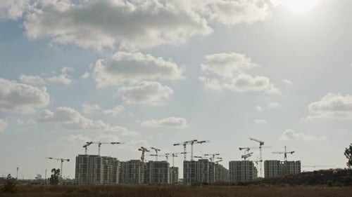 Large construction site with many cranes working over buildings