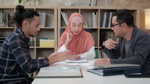 A group of Muslim startup team discussions in a small office.
