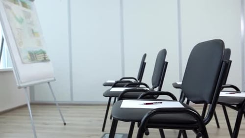 Empty Meeting Room with Chairs and Flip Chart