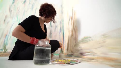 Female Artist Painting an Abstract Painting in Studio