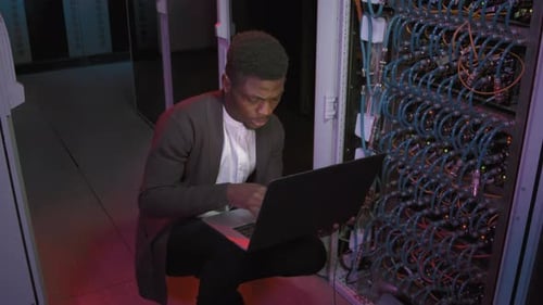 Black Male Network Engineer Working in Data Center