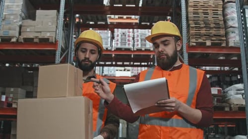 Workers Walking Through Warehouse
