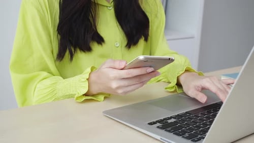 Closeup hand of young asian businesswoman working on laptop computer on desk at home office.