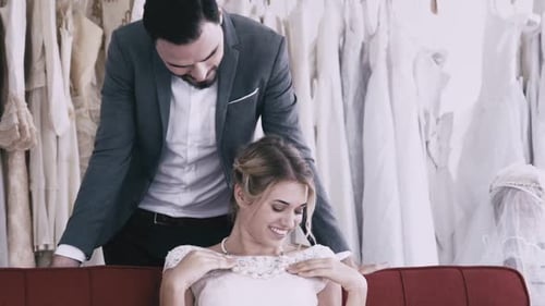 Couple Shopping for Wedding Dress in Bridal Store