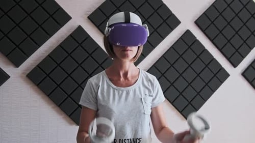 Woman Uses Virtual Reality Headset and Controllers