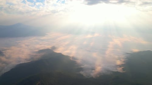 Flying over the clouds during morning sunrise