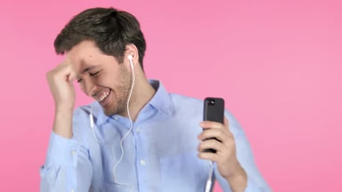 Young Adult Man Dancing While Using Smart Phone