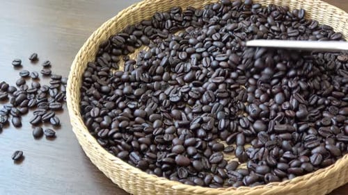 Roasted Coffee Beans Stirred in Woven Round Tray