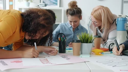 Slow Motion of Cheerful Women Making Posters About Feminism and Talking Enjoying Creative Activity