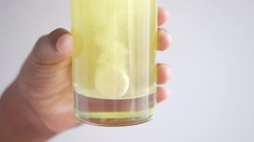 Effervescent Tablet Dissolving in Glass of Water