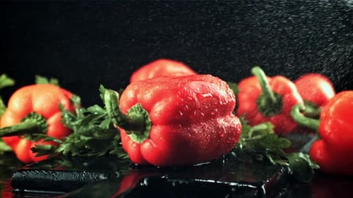 Drops of Water Fall on Fresh Sweet Peppers