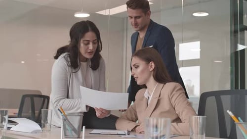 Team Collaborating on Documents in Modern Office