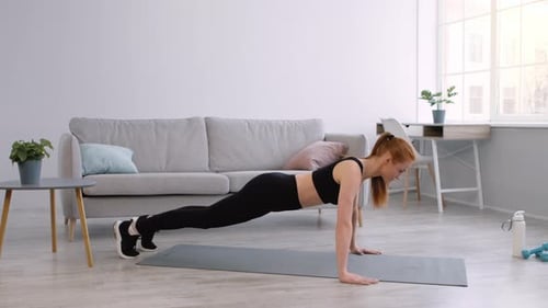 Fit Woman Exercising Indoors Doing Push-Ups