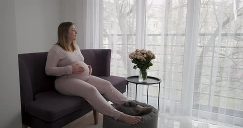Expecting Woman Relaxing at Home with Pet Cat