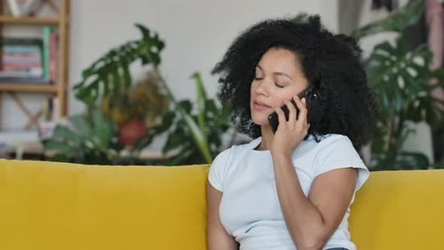 Young Woman Talking on Phone Indoors