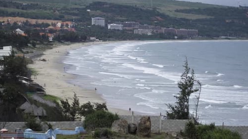 Rapidly decreasing sand area of Malibu beach in Mui Ne, Vietnam, distance static view