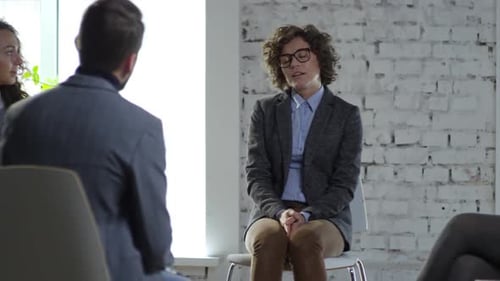 Adults in Group Therapy Session in Bright Room