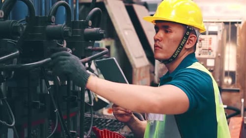 Smart Factory Worker Using Machine in Factory Workshop