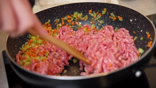 Woman Cooking Sauce Bolognese in Kitchen