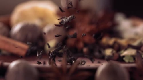 Black Tea Pouring Over Spices in Slow Motion