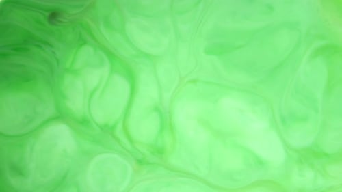 Footage. Ink in Water. Green Ink Reacting in Water Creating Abstract Background.