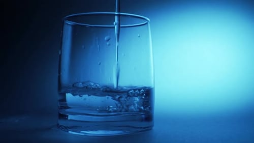 Water Being Poured into a Glass Cup