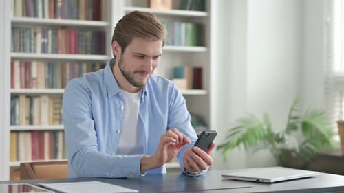 Excited Man Celebrating Good News on Phone