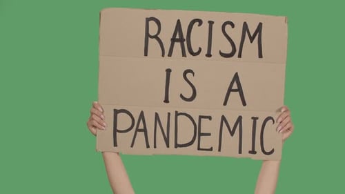 Cardboard Sign Declares Racism Is a Pandemic