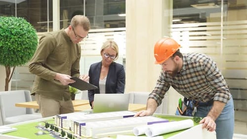 Three Architects Engineers Coworking Modern Office Inspecting 3d Model Building